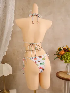 Rear view of bikini with colorful tropical fruit prints and shell waist chain