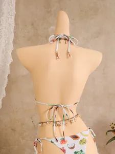 Detail view of fruit print bikini set with golden waist chain and shell charms