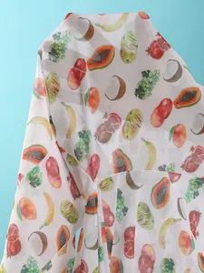 Close-up of mesh fabric with vibrant tropical fruit prints including papaya and banana