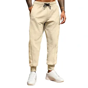 Men's loose joggers in beige featuring elastic waistband and tapered ribbed cuffs