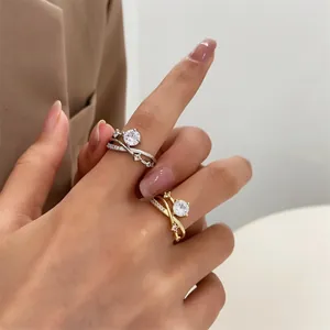 Macro detail of intertwined crown rings with sparkling round-cut cubic zirconia stones