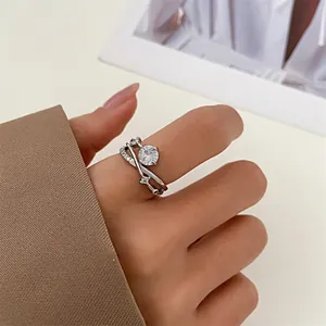 Detail of classic crown ring with six-prong zircon and double-layer crossover design