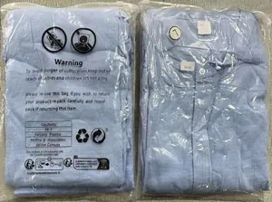 Detail of light blue long sleeve shirts in PE packaging with L size labels