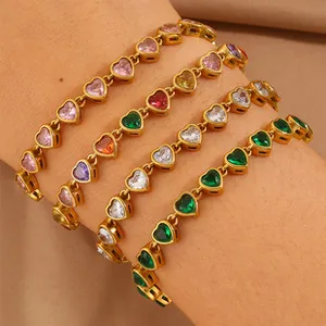 Macro detail of gold plated heart bracelets with multi-color zircon inlay on wrist
