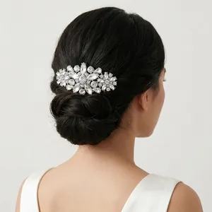 Detail of silver bridal hair comb with white rhinestones on a back hair bun