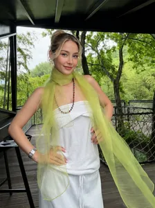 Close-up of lightweight lime yellow silk-like scarf with shimmering texture and sheer finish