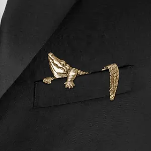 Creative gold crocodile brooch pin with rhinestone scales on black suit jacket