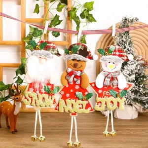 Detail of Christmas plush ornaments with Joy, Noel, Snow text and golden bell accents