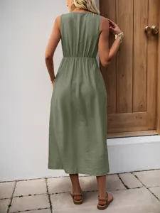 Detail of sage green sleeveless midi dress featuring an elastic waist and textured fabric