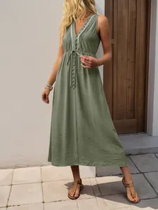 Detail of V-neckline with decorative buttons and drawstring waist on olive green dress