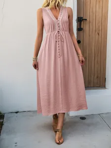 Detail of light pink V-neck maxi dress featuring floral embroidery and drawstring waist