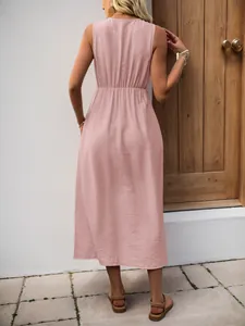 Rear view of pink sleeveless midi dress with elastic smocked waist detail