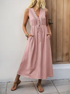 Detail of V-neck sleeveless maxi dress with drawstring waist and button accents