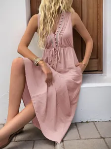 Detail of V-neck sleeveless dress with button accents and drawstring waist in dusty rose