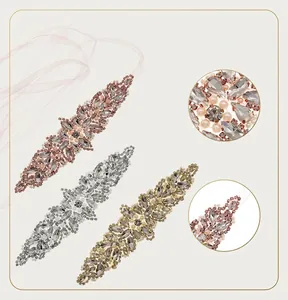 Macro detail of rhinestone bridal belt with pearls and crystal leaf patterns on ribbon