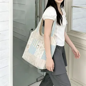 Dettaglio della borsa tote patchwork floreale con trama del tessuto ed etichetta