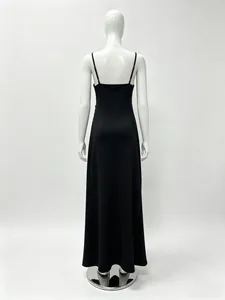 Detail view of the back cut and thin straps of this elegant black slit evening dress