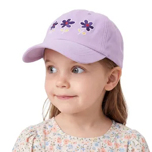 Close-up of small flower embroidery on a light purple cotton girl's baseball cap