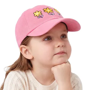 Detailed embroidery of three yellow flowers on a pink cotton girl's baseball cap