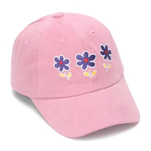 Close-up of pink cotton baseball cap featuring purple flower embroidery on the crown
