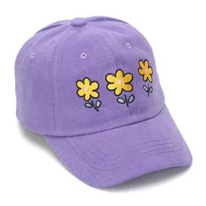 Detailed close-up of yellow flower embroidery on light purple cotton baseball cap