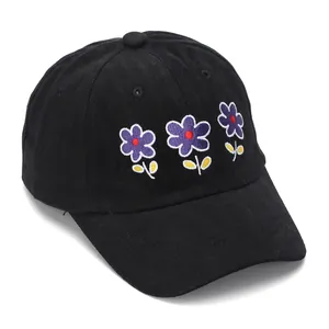 Close-up of violet floral embroidery on breathable black cotton baseball cap