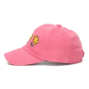 Detail of pink cotton baseball cap with yellow flower embroidery and adjustable buckle