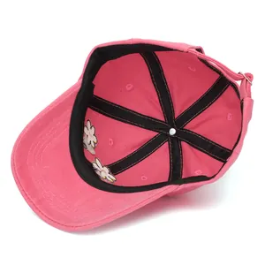 Detail view of pink baseball cap interior showing stitching and daisy flower embroidery