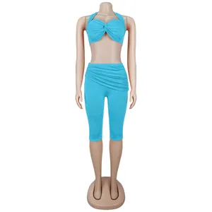 Detail of blue two-piece set featuring halter neck knot top and high waist shorts
