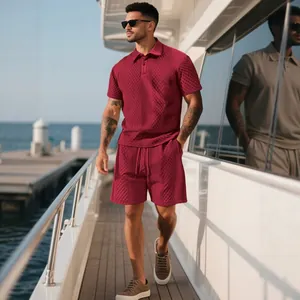 Burgundy men's knit polo shirt and shorts set with textured diamond pattern in sun