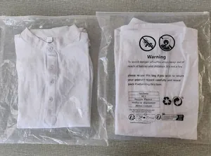 Close-up of white linen-blend shirts showing 50% linen fabric texture and packaging