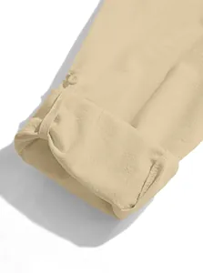 Detailed macro view of the linen blend sleeve with a button and rolled cuff design