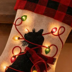 Detail of light-up Christmas stocking with LED lights and black cat embroidery