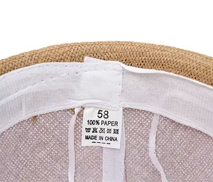 Detail of summer straw hat interior with 100% paper material and size 58 labels