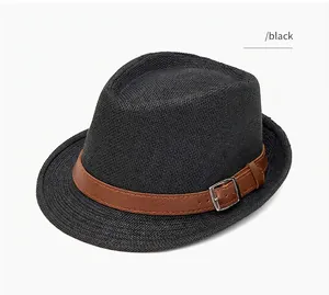 Detail view of black woven straw fedora hat with brown leather band and silver metal buckle