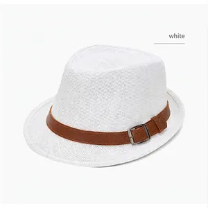 Close-up of white woven Fedora hat with brown leather band and metal buckle detail