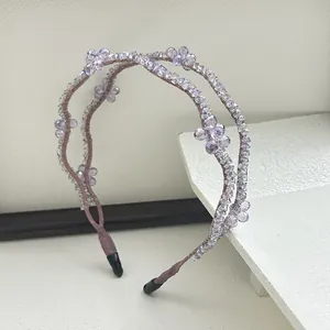 Detailed view of woven double-layered crystal beads on a lilac floral headband