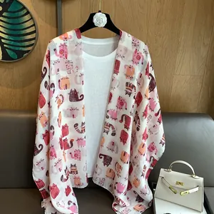 Detail of thin cotton linen shawl featuring cute colorful cartoon cat prints
