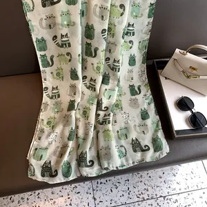 Detail of cute cartoon cat print on a cream cotton linen scarf with fine edge stitching