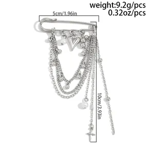 Detail view of multi-layer safety pin brooch with silver chains and heart charms