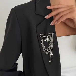 Star and heart multilayer chain brooch with pearls styled on a black suit lapel