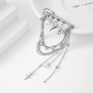 Detail view of silver layered chain brooch with heart charms and faux pearls