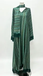 Detail of V-neck long sleeve dress with zigzag pattern and fringe trim finish