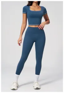 Detail showing white piping on grey blue high-waisted yoga leggings and crop top set
