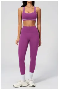 Women's purple high-waisted yoga leggings and sports bra set with white contrast trim