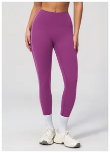 Detail of high waisted purple yoga leggings with side stripe contrast on female model