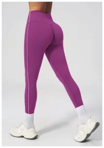 Detail of high-waisted purple yoga leggings featuring contrasting side stripes and slim fit