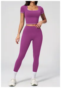 Detail of shadow purple yoga set featuring white contrast binding on the crop top and leggings