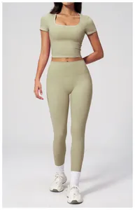 Close-up of high-waist light green yoga leggings with white contrast stitching details