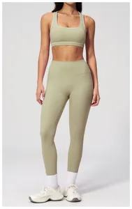 Detail view of high-waist green yoga leggings and racerback sports bra set